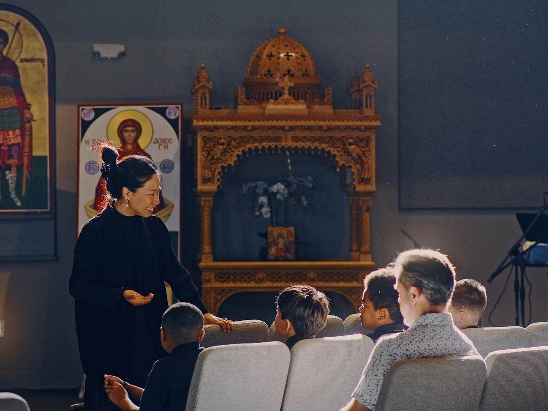 Students seated in the pews before the icons as the school day begins