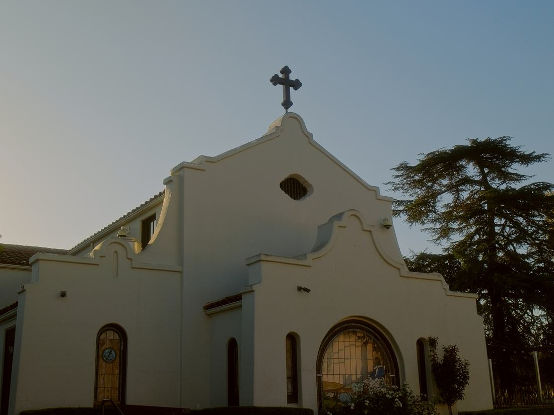 St. Basil Greek Orthodox Church and its cross against the trees
