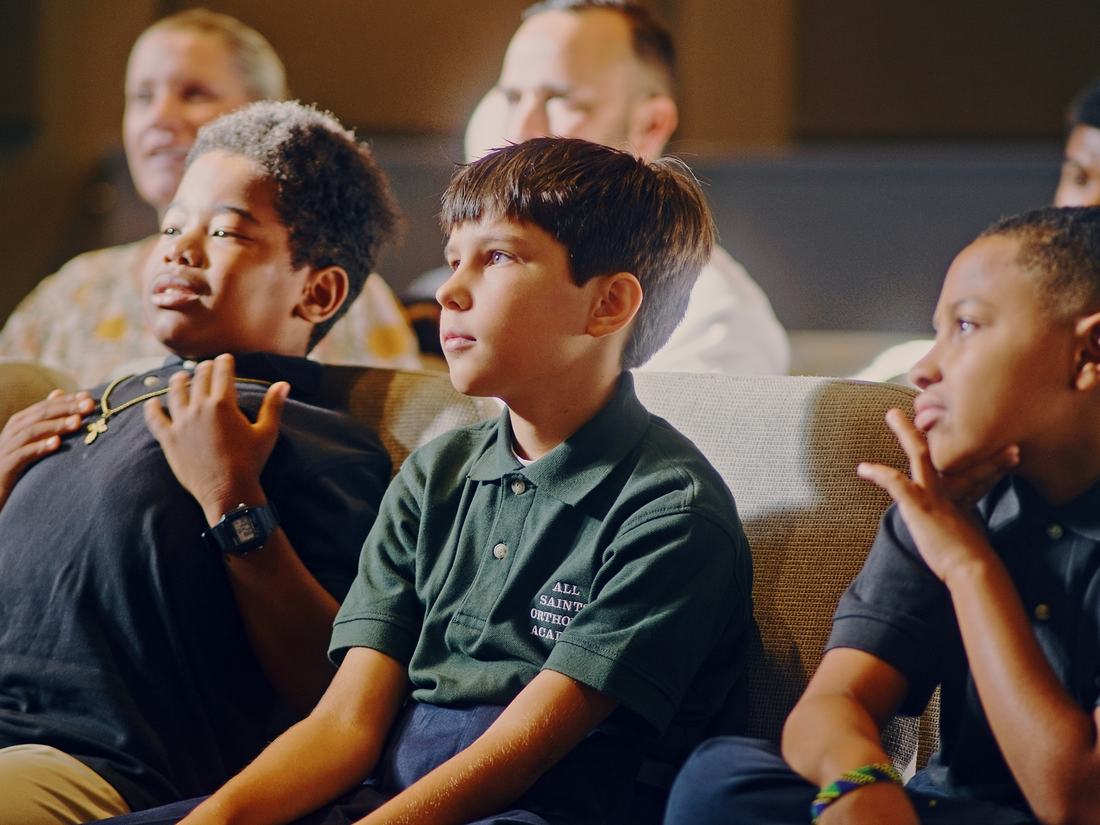 Three students listening during the blessing