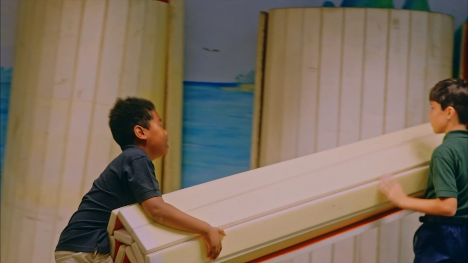 Two students carrying a pew together
