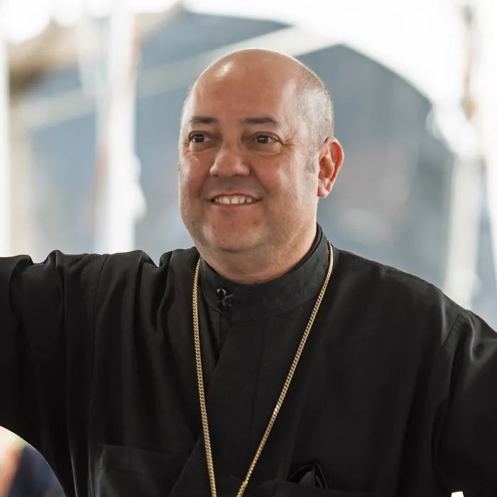Fr. Vasilios “Bill” Tragus greeting the parish with both arms open